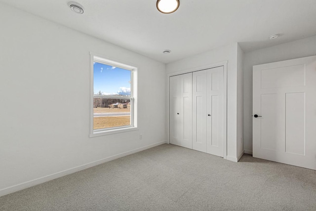 2834 Meadowview Ln NE, Owatonna, MN 55060 - unfurnished bedroom featuring carpet flooring, baseboards, and a closet