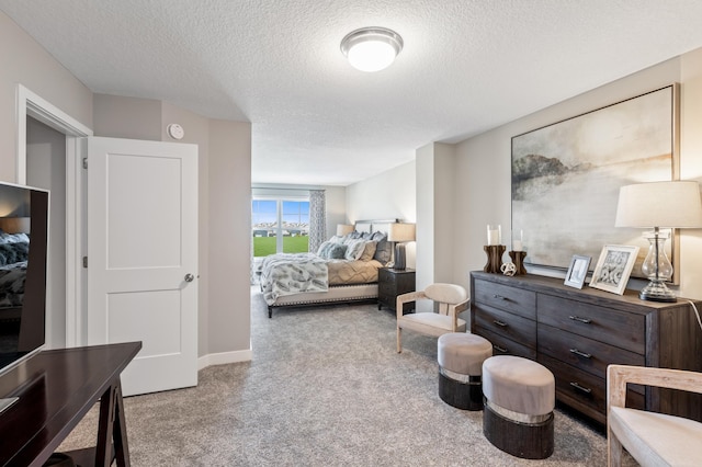 carpeted bedroom featuring a textured ceiling