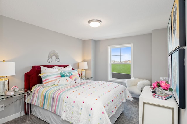 bedroom with dark colored carpet