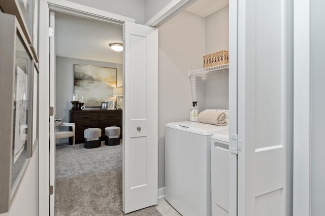 washroom featuring washing machine and dryer and light colored carpet