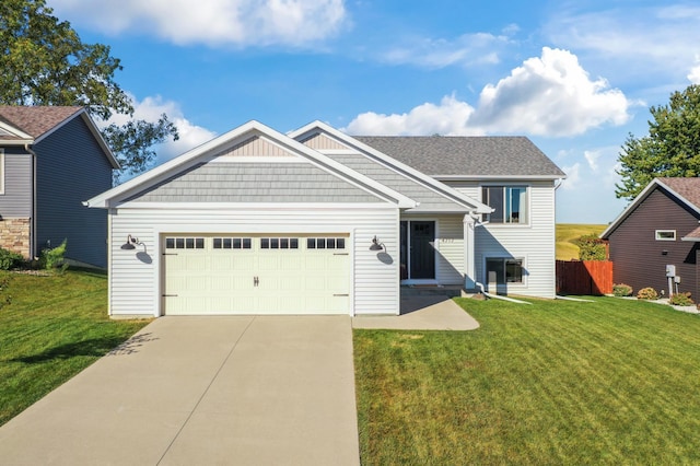 view of front of house featuring a garage, concrete driveway, and a front lawn