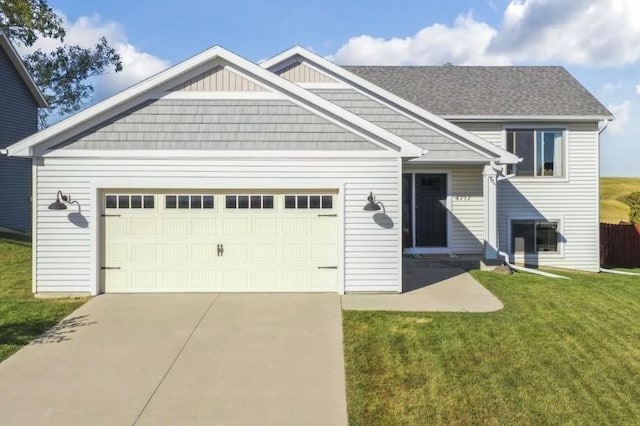 view of front facade with a garage, a front lawn, and concrete driveway