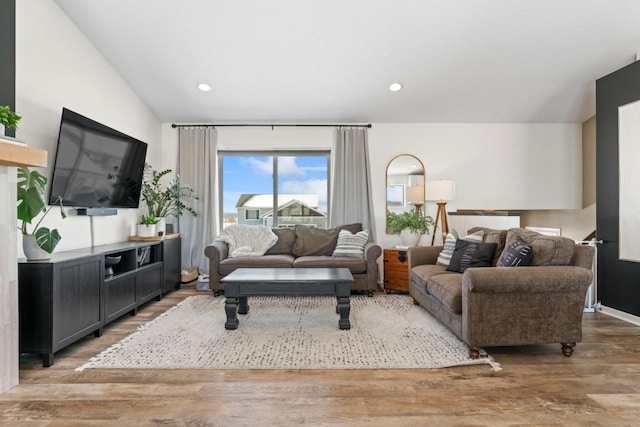 living area with light wood-style floors, recessed lighting, and lofted ceiling