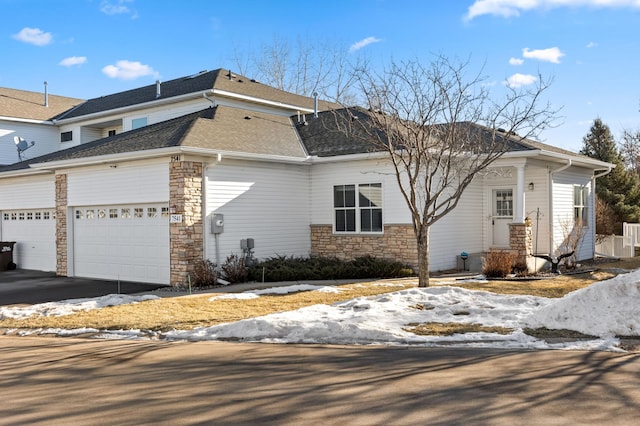 snow covered property with a garage