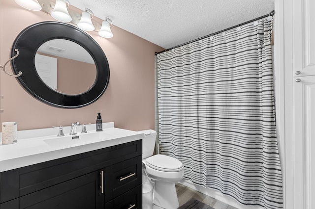 bathroom featuring hardwood / wood-style flooring, vanity, toilet, a textured ceiling, and a shower with shower curtain