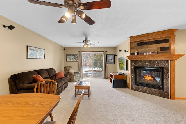 living room with carpet, a textured ceiling, and a fireplace