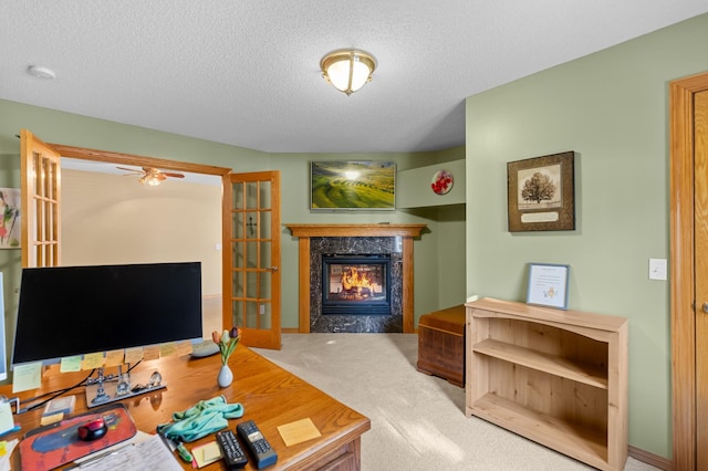 living room featuring a high end fireplace, carpet flooring, and a textured ceiling