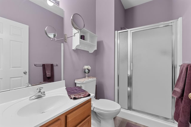 bathroom featuring vanity, toilet, and walk in shower