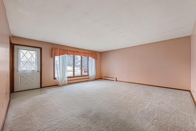 unfurnished living room featuring a baseboard radiator and light colored carpet