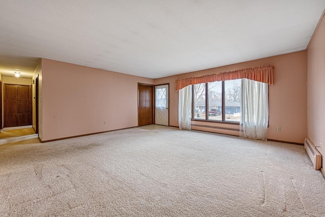 carpeted empty room featuring a baseboard radiator