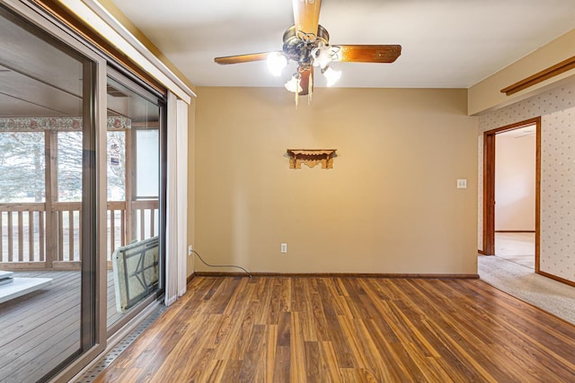 spare room featuring ceiling fan and dark hardwood / wood-style flooring