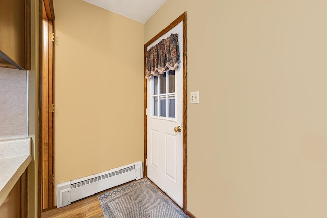 entryway featuring baseboard heating and light hardwood / wood-style floors