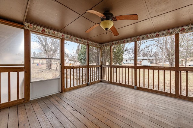 unfurnished sunroom with ceiling fan