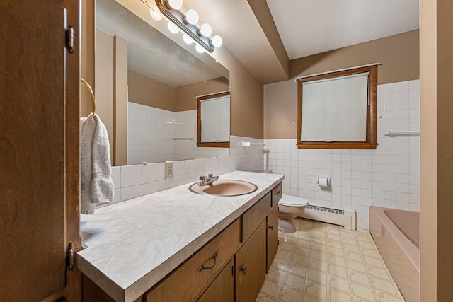 full bathroom with toilet, tile walls, a baseboard radiator, separate shower and tub, and vanity