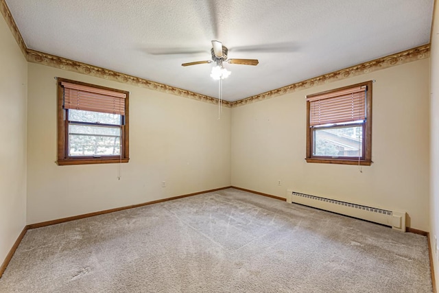 carpeted empty room featuring a baseboard radiator, a textured ceiling, and ceiling fan