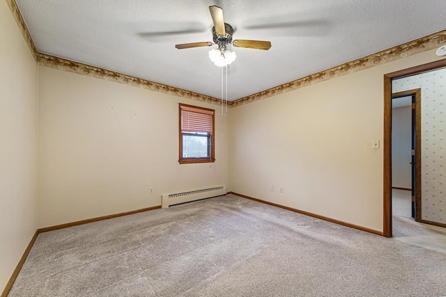 carpeted spare room with a baseboard radiator, a textured ceiling, and ceiling fan