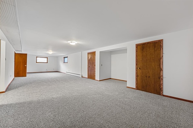 basement with light colored carpet and a baseboard radiator