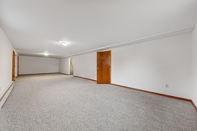 empty room with a baseboard radiator and light carpet