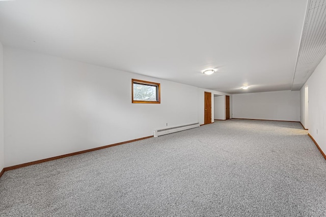 basement with baseboard heating and carpet flooring