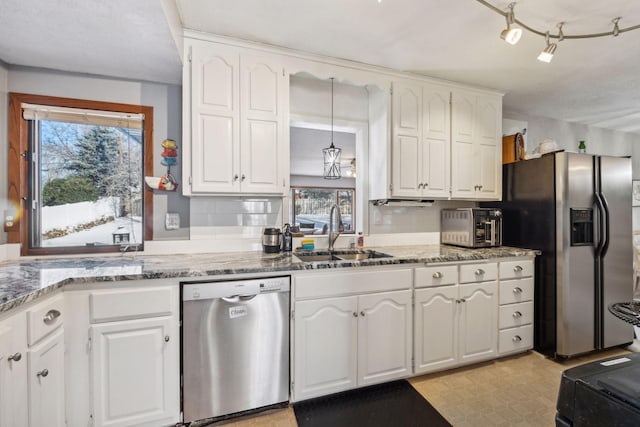 kitchen with sink, stainless steel appliances, white cabinets, and stone counters