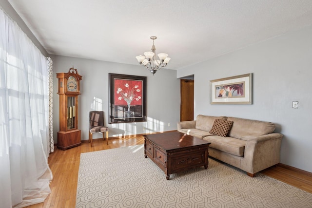 living room featuring a chandelier and light hardwood / wood-style floors