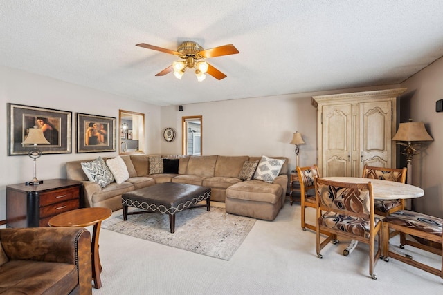 carpeted living room with a textured ceiling and ceiling fan