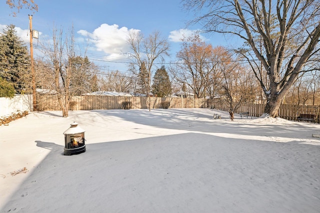 snowy yard featuring a fire pit