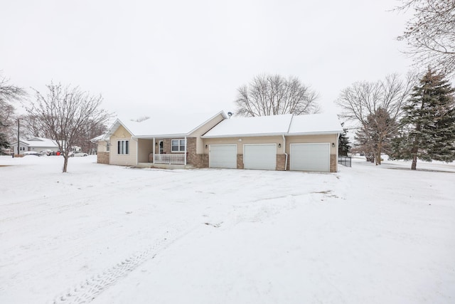 single story home featuring a garage and a porch