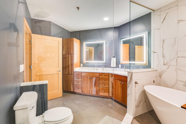 bathroom featuring toilet, a sink, tile walls, a soaking tub, and double vanity