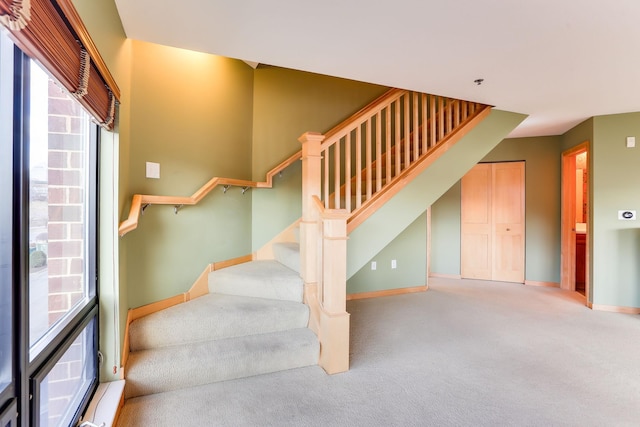 stairs featuring carpet floors and baseboards