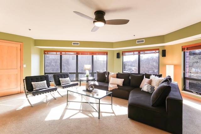 carpeted living room with visible vents and a ceiling fan