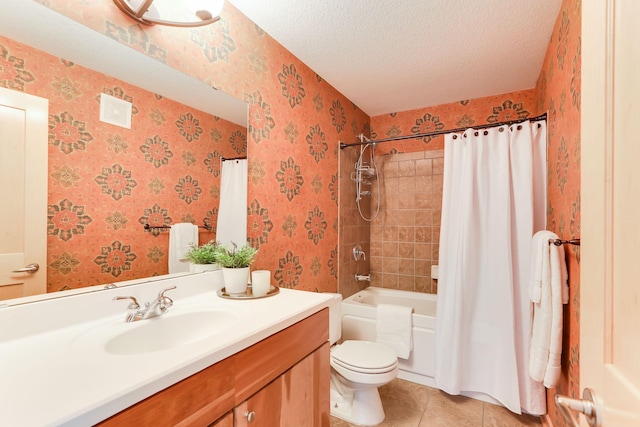 bathroom featuring a textured ceiling, tile patterned flooring, toilet, vanity, and wallpapered walls