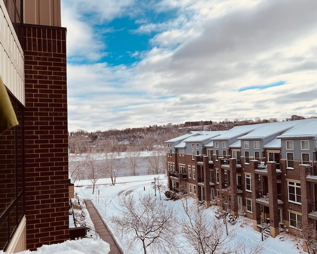 yard layered in snow with a residential view