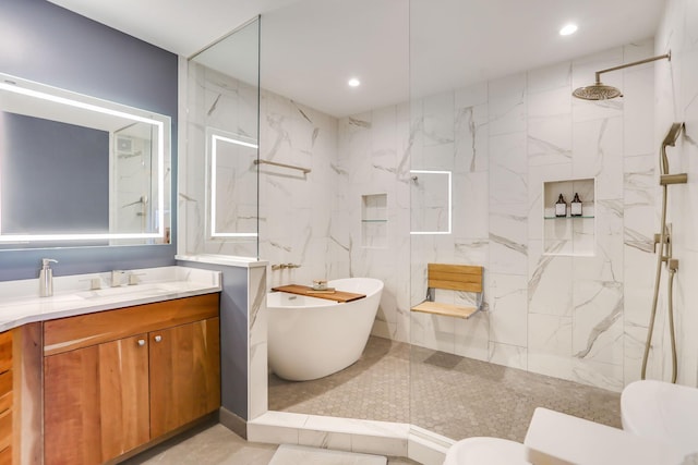 312 Spring St Unit 309, Saint Paul, MN 55102 - full bath with vanity, a marble finish shower, a freestanding bath, and recessed lighting