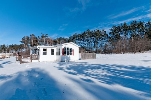 view of snow covered back of property