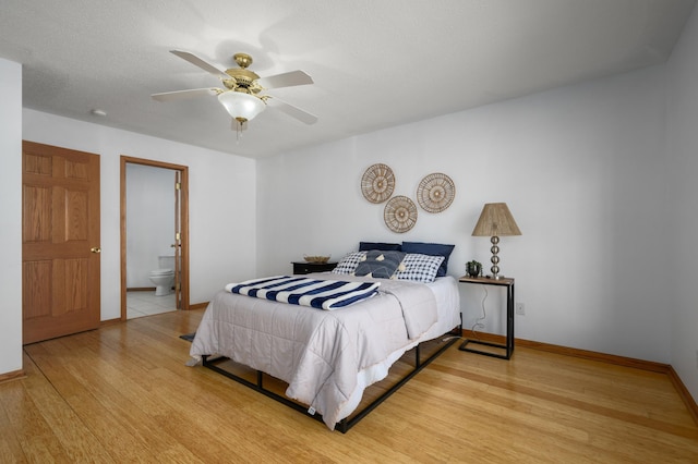 bedroom featuring connected bathroom, ceiling fan, and light hardwood / wood-style floors