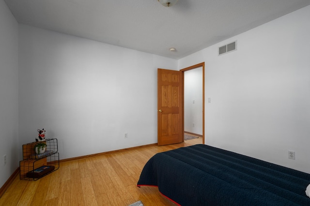 bedroom with hardwood / wood-style floors