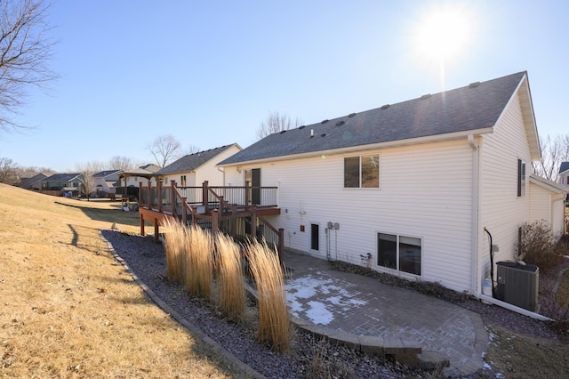 back of house featuring a patio area, central AC, a lawn, and a deck