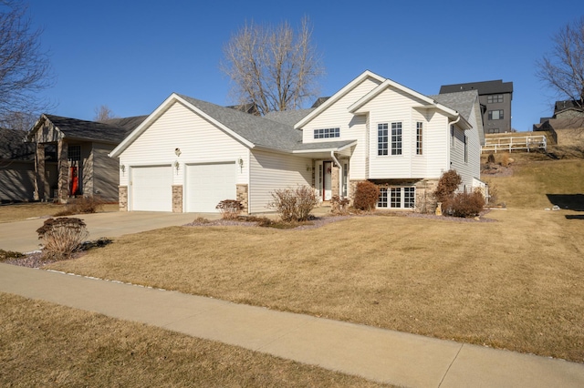 view of front of house featuring a garage and a front lawn