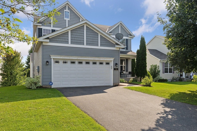 view of front of home featuring a garage and a front yard