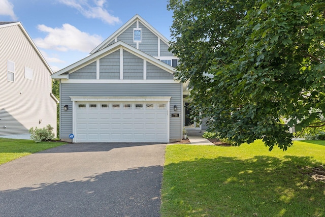 view of front facade with a garage and a front lawn