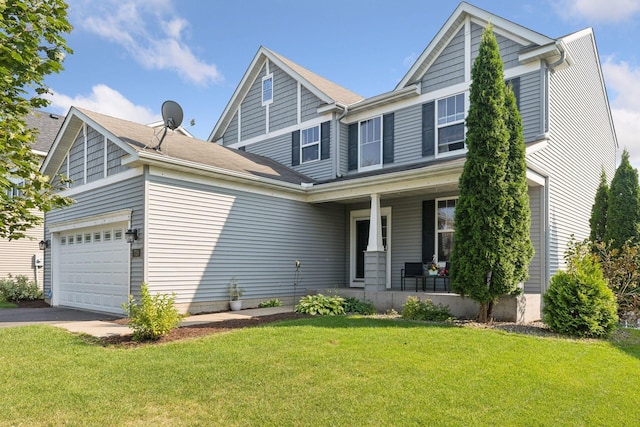 view of front facade featuring a garage, covered porch, and a front lawn