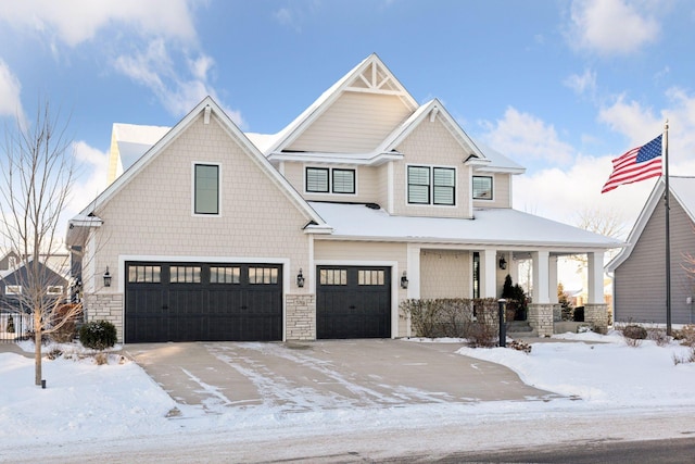 view of front of property with a garage and covered porch