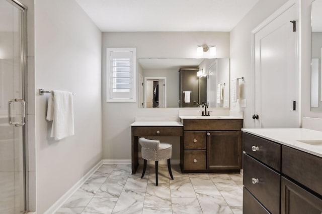 bathroom with marble finish floor, two vanities, a sink, and a shower stall