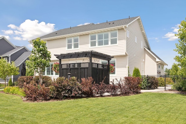 back of house with a lawn, fence, and a pergola