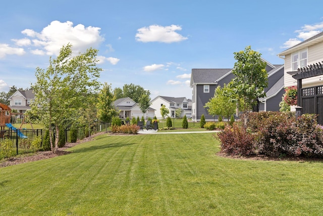 view of yard with a residential view and fence