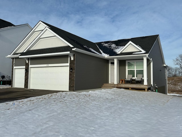 view of front facade with covered porch and a garage