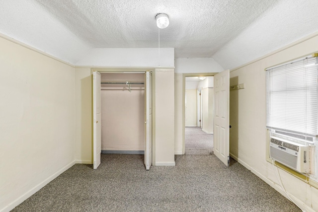 unfurnished bedroom featuring carpet flooring, cooling unit, a closet, and vaulted ceiling