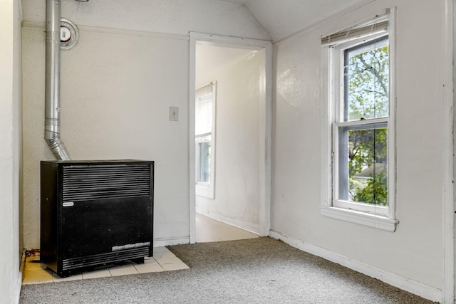 living room featuring heating unit, light colored carpet, and lofted ceiling