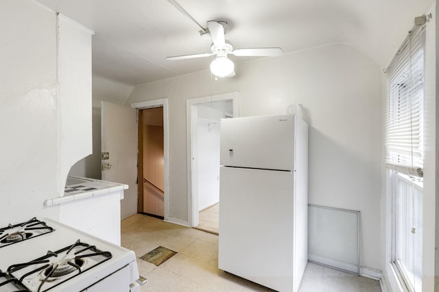 kitchen featuring vaulted ceiling, tile countertops, ceiling fan, and white appliances